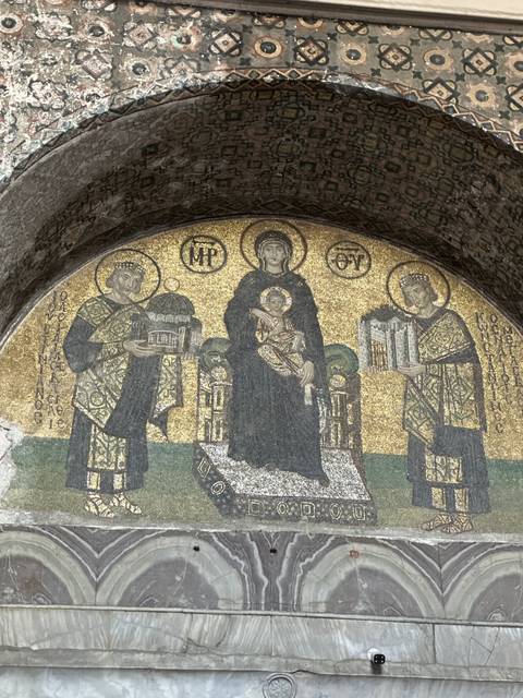       Mosaic art piece with religious figures.
  