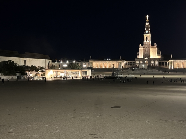 Night view of an illuminated square and church.