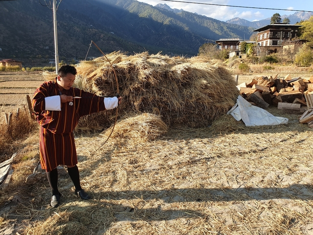       Traditional Bhutanese man practicing archery.
  