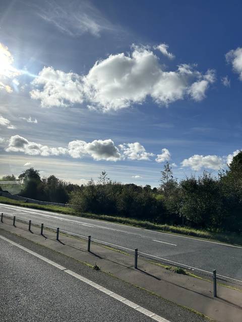 Road with clouds in the sky.