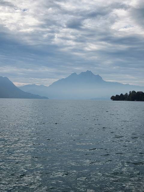 Mountain lake with cloudy sky.