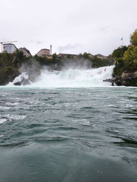 Large waterfall and buildings in the background.