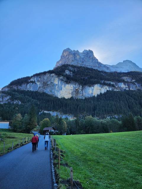 People walking along a path in a mountainous area.