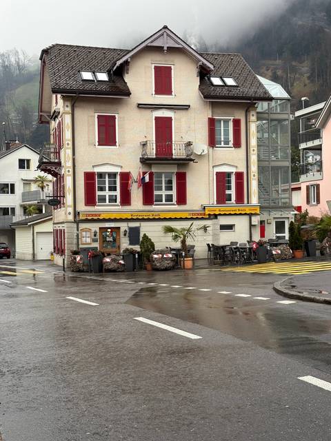Traditional European building with red shutters.