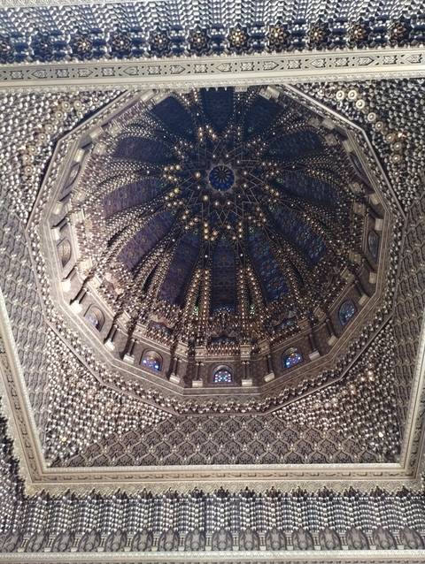 Intricately decorated ceiling of a historical building with geometric patterns.