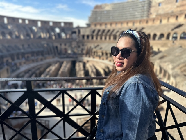 A person posing inside the Colosseum.