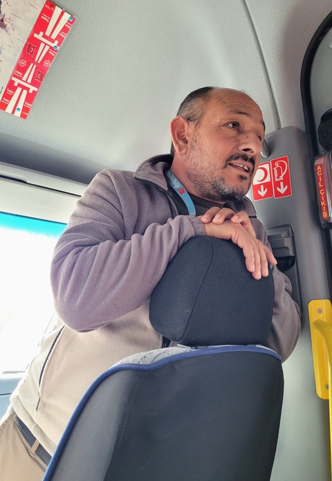 Person inside a vehicle speaking.