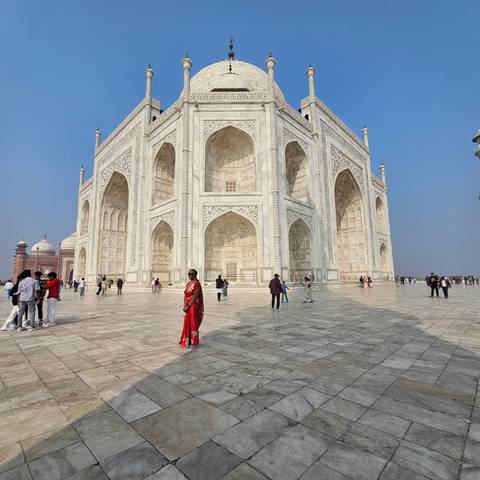 Woman in a red sari at the Taj Mahal.