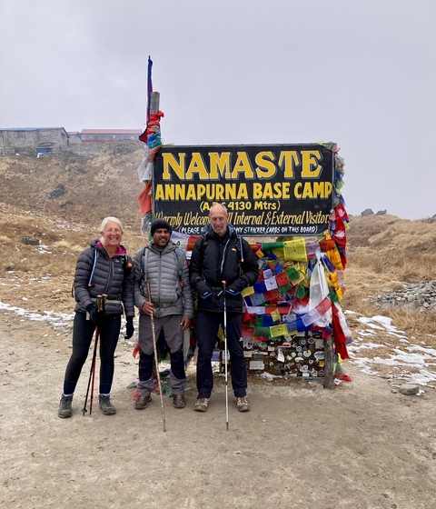 Group at Annapurna Base Camp with a welcome sign.