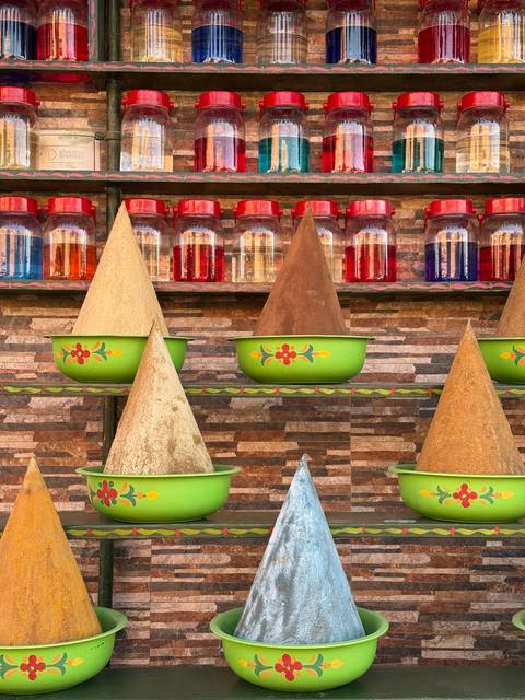       Colorful cones and jars in a display.
  