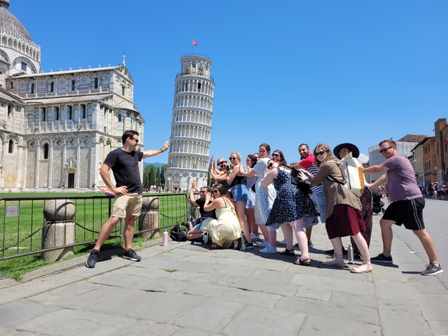       Tourists posing creatively with the Leaning Tower of Pisa
  