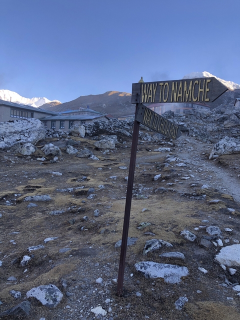       Trail sign pointing to Namche and other locations
  