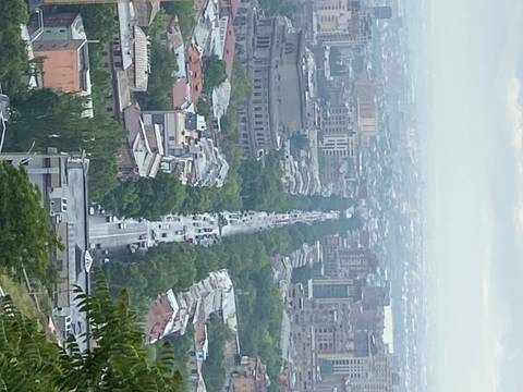 Cityscape view with a distant hilly skyline.
