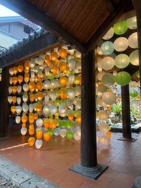       Colorful lanterns hanging from a ceiling.
  