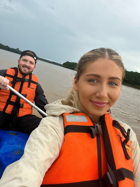 Two people kayaking on a river.