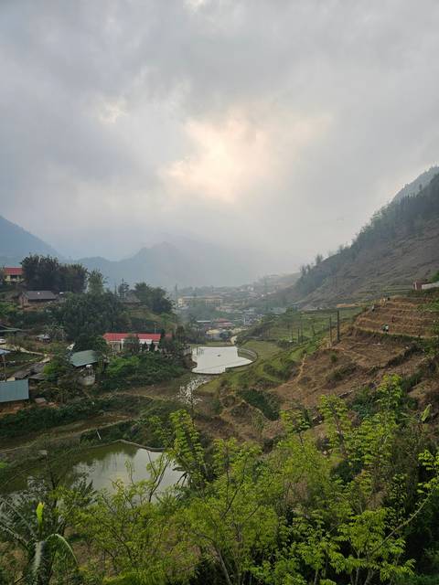       Scenic view of a valley with fields and a river.
  