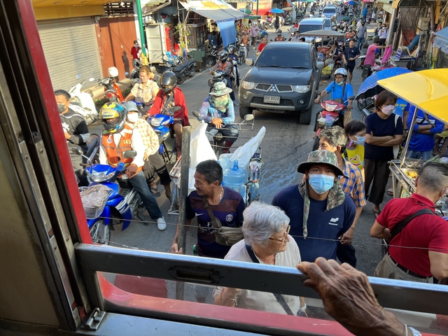       A crowded market street seen from a window.
  