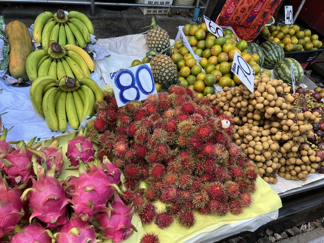 A display of various colorful fruits at a market.