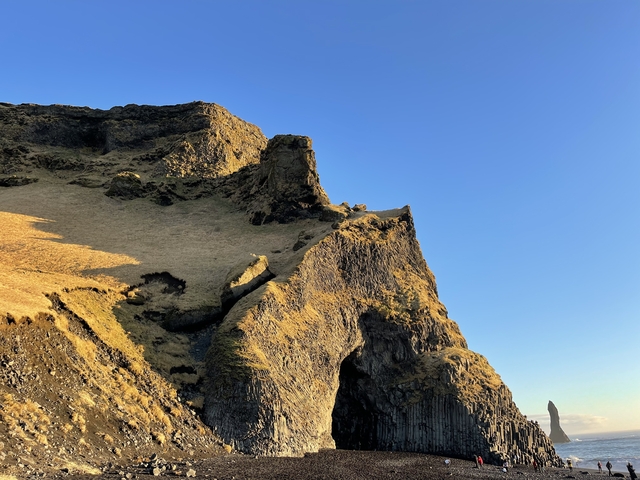       Rocky hill with a clear blue sky.
  
