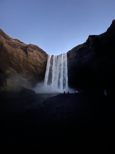       Waterfall with people in the foreground.
  