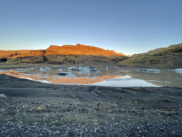 Glacial lake with mountains in the background.