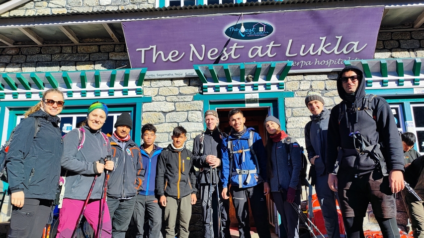 Group of hikers posing in front of a building in Lukla.