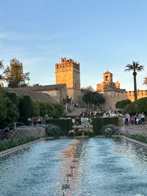 Large courtyard with reflecting pool and historic architecture.