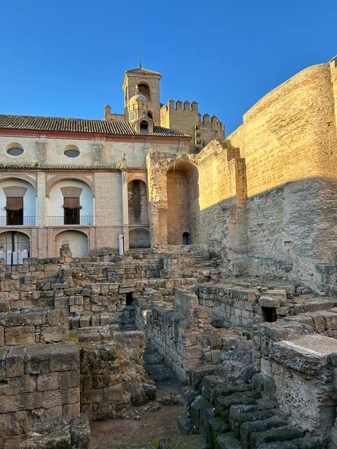 Stone ruins adjacent to a historic building.