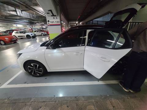 White car parked in an indoor parking area.
