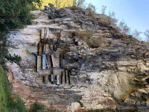 Hanging coffins on a cliff face.