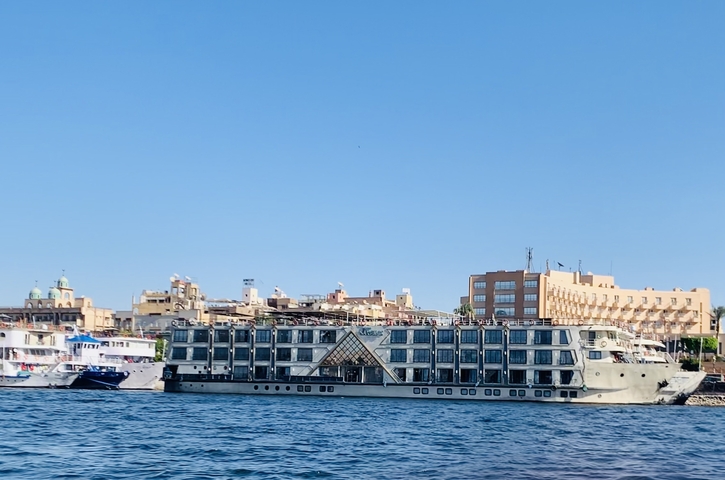       Large river cruise ship docked in the city.
  
