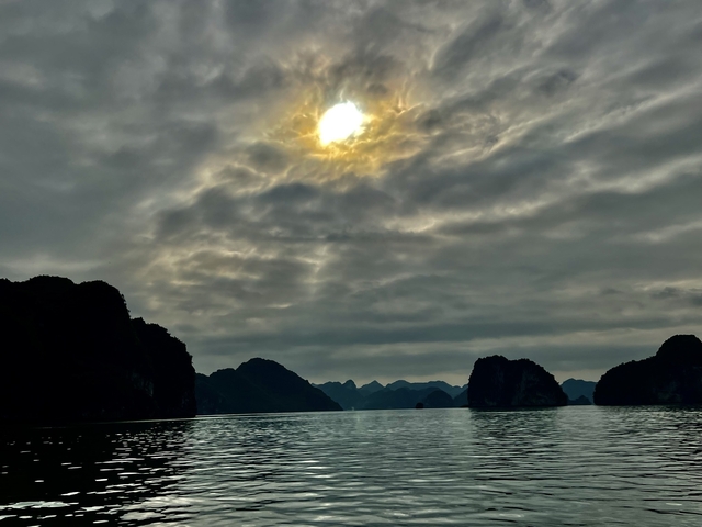 Sun filtering through the clouds over the sea.
