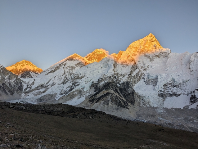 Sunlit snow-covered mountain peaks with dramatic lighting.