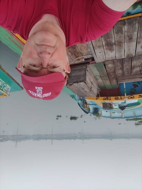 Selfie with a person on a boat overlooking a river.