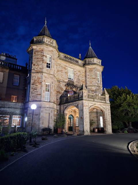 Illuminated stone building at night.