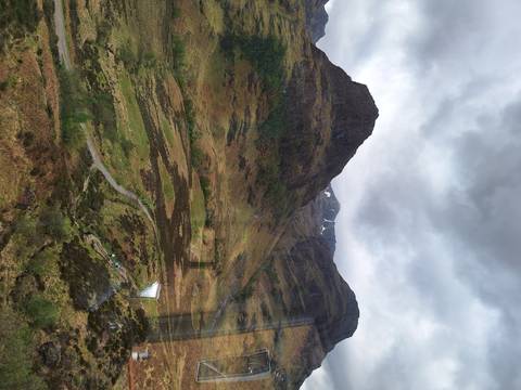       Mountainous landscape with cloudy sky.
  