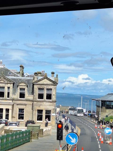       Coastal view with sea and historic building.
  