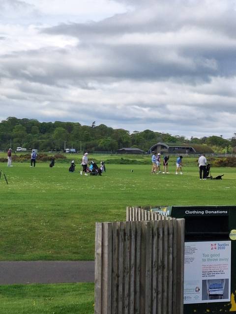Golf course with people playing.