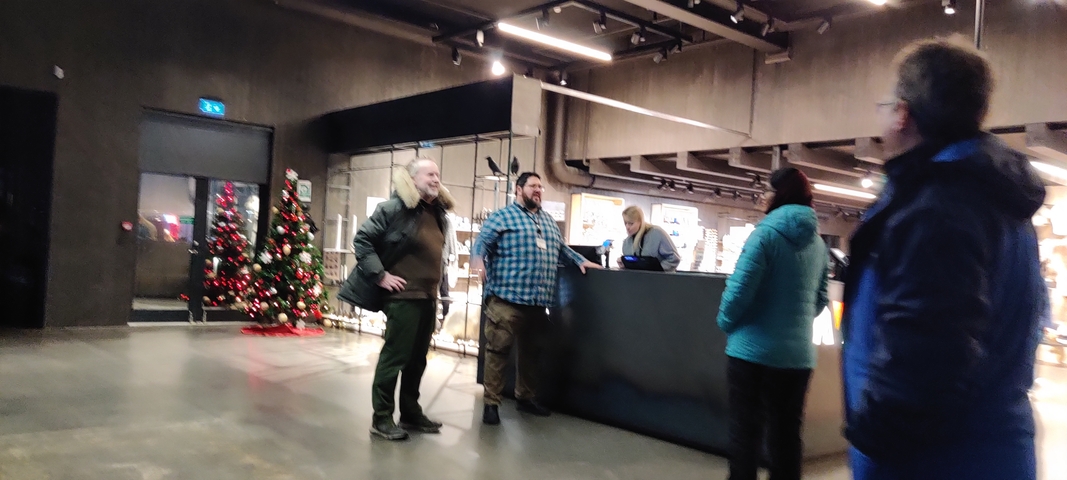       Group of people at a reception area with Christmas decorations
  