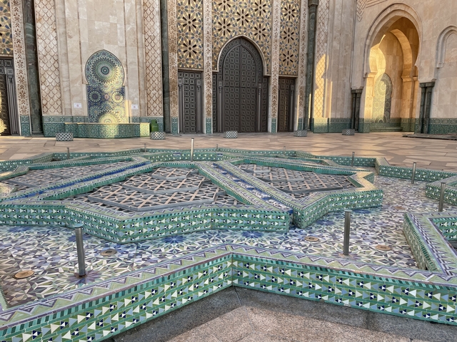 Intricate tiled floor and architecture at a mosque.