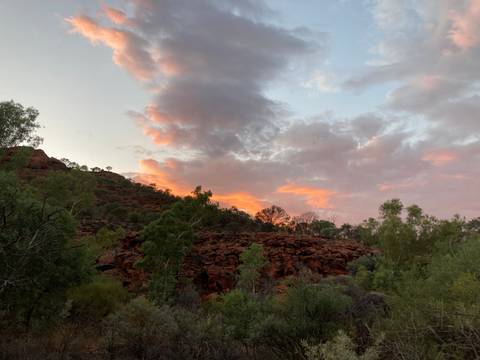 A rocky cliff with sunset clouds.