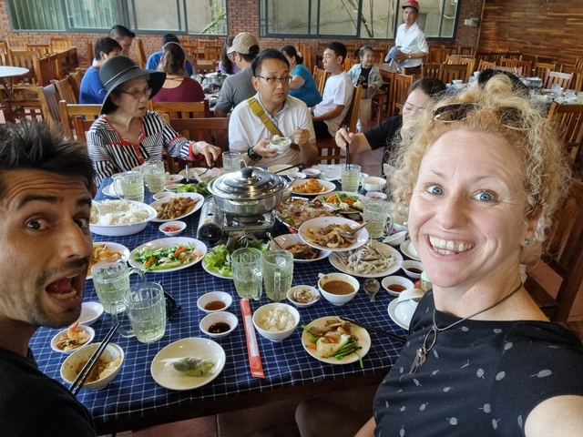 Group of people enjoying a traditional Vietnamese meal.