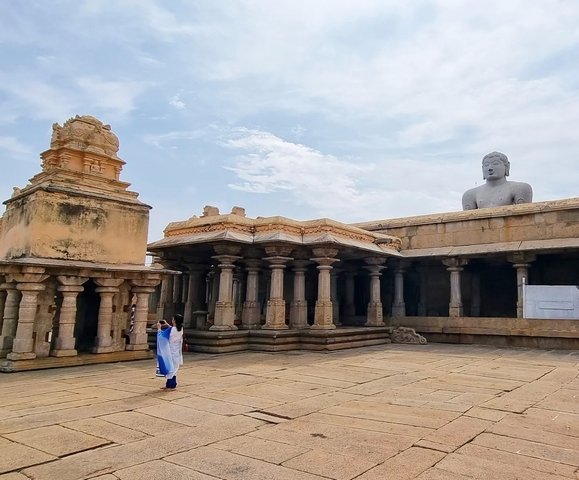       Altar and giant statue within an open temple courtyard.
  