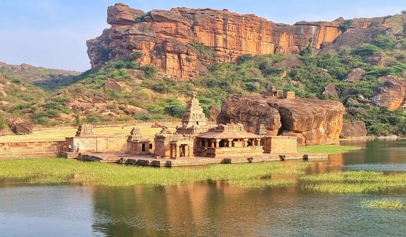       Ancient stone temple sitting on a rocky lakeshore.
  