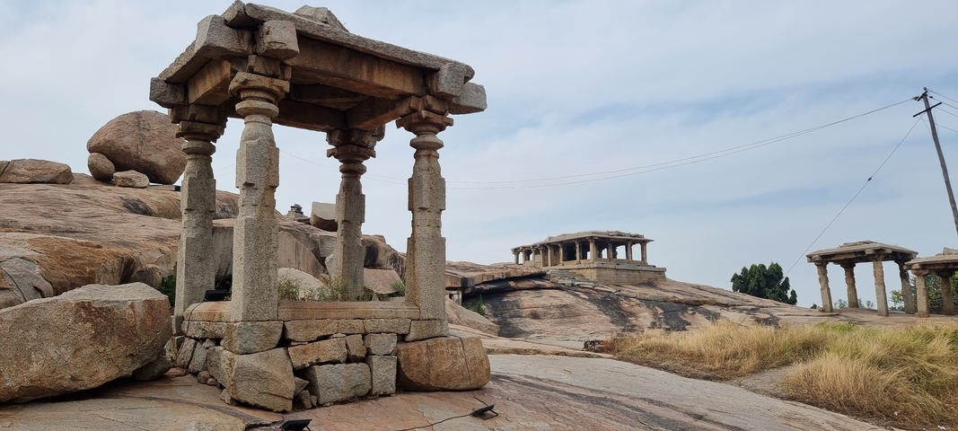       Ancient stone pavilion on rocky terrain.
  
