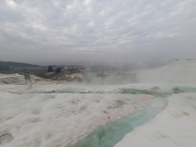       Pamukkale thermal pools with steam rising.
  