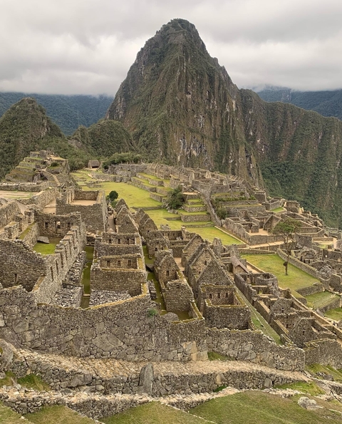       Close-up view of Machu Picchu ruins with mountains in the background.
  
