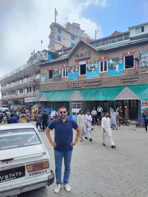 Person in front of a busy marketplace street.