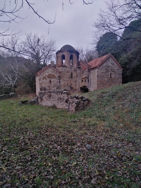       Old stone church in a natural setting.
  