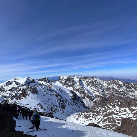 Snow-covered mountain peaks under a clear blue sky.